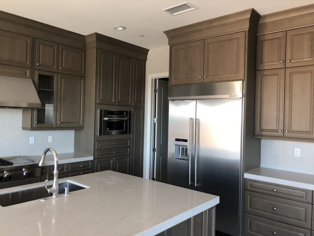 Finished kitchen with a built-in stainless refrigerator serviced by A Plus Appliance Care
